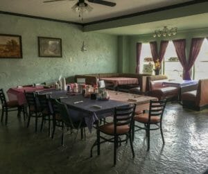 A formal dining area accommodates large groups at Buzzy Cafe in Beach.